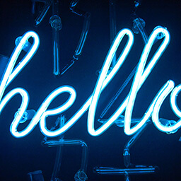 A blue neon sign with the word HELLO.