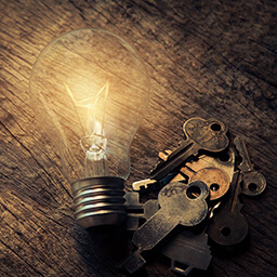 A lightbulb shines a light on some keys, symbolyzing the keywords that you're searching for.